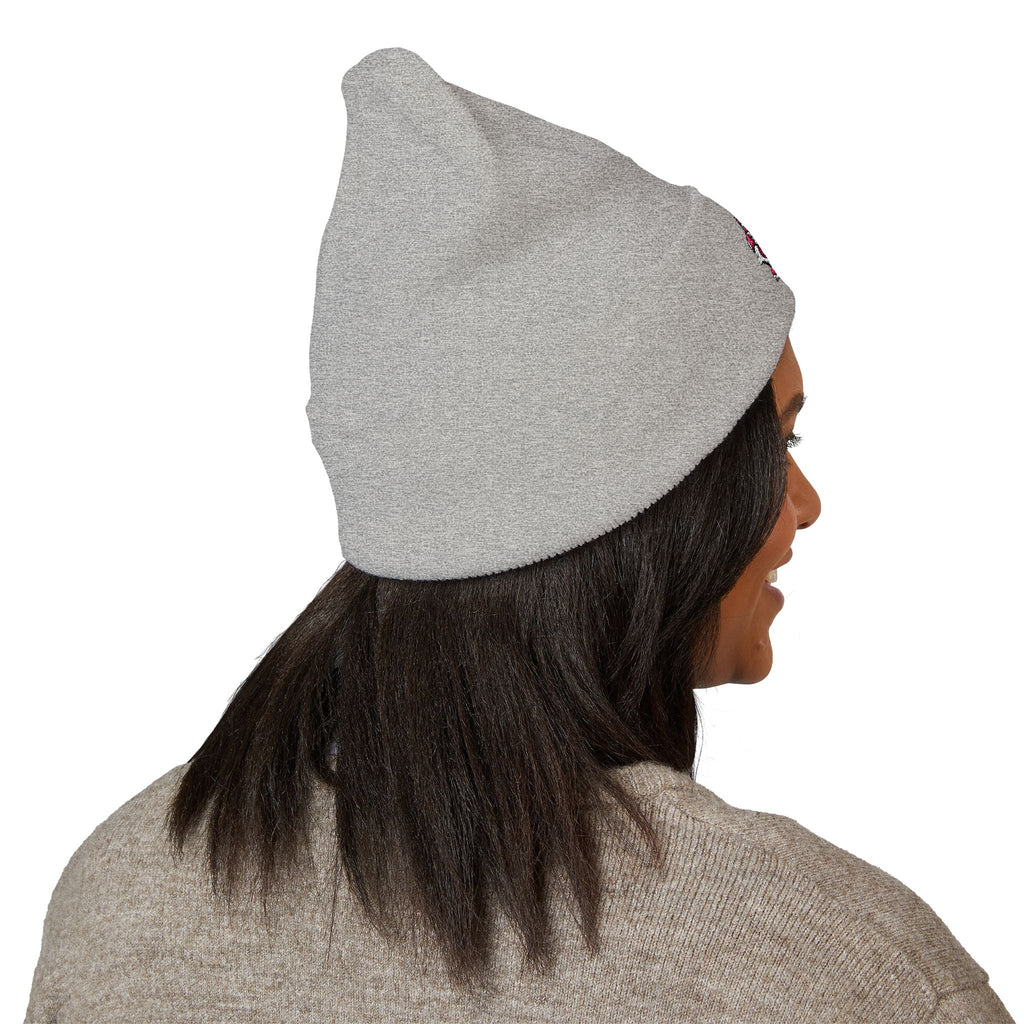 Person wearing a gray beanie on a white background
