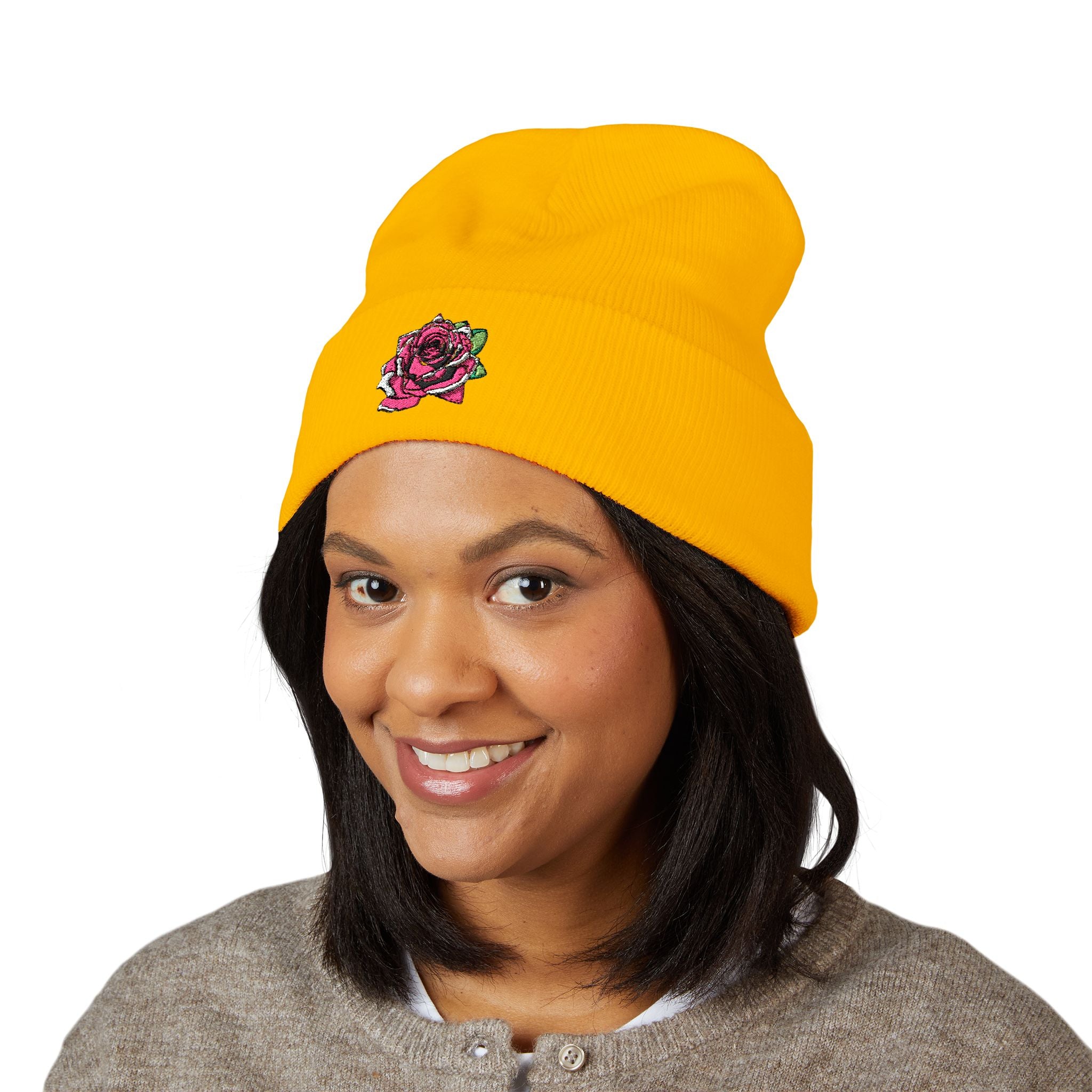 Person wearing a yellow beanie with a logo on a white background