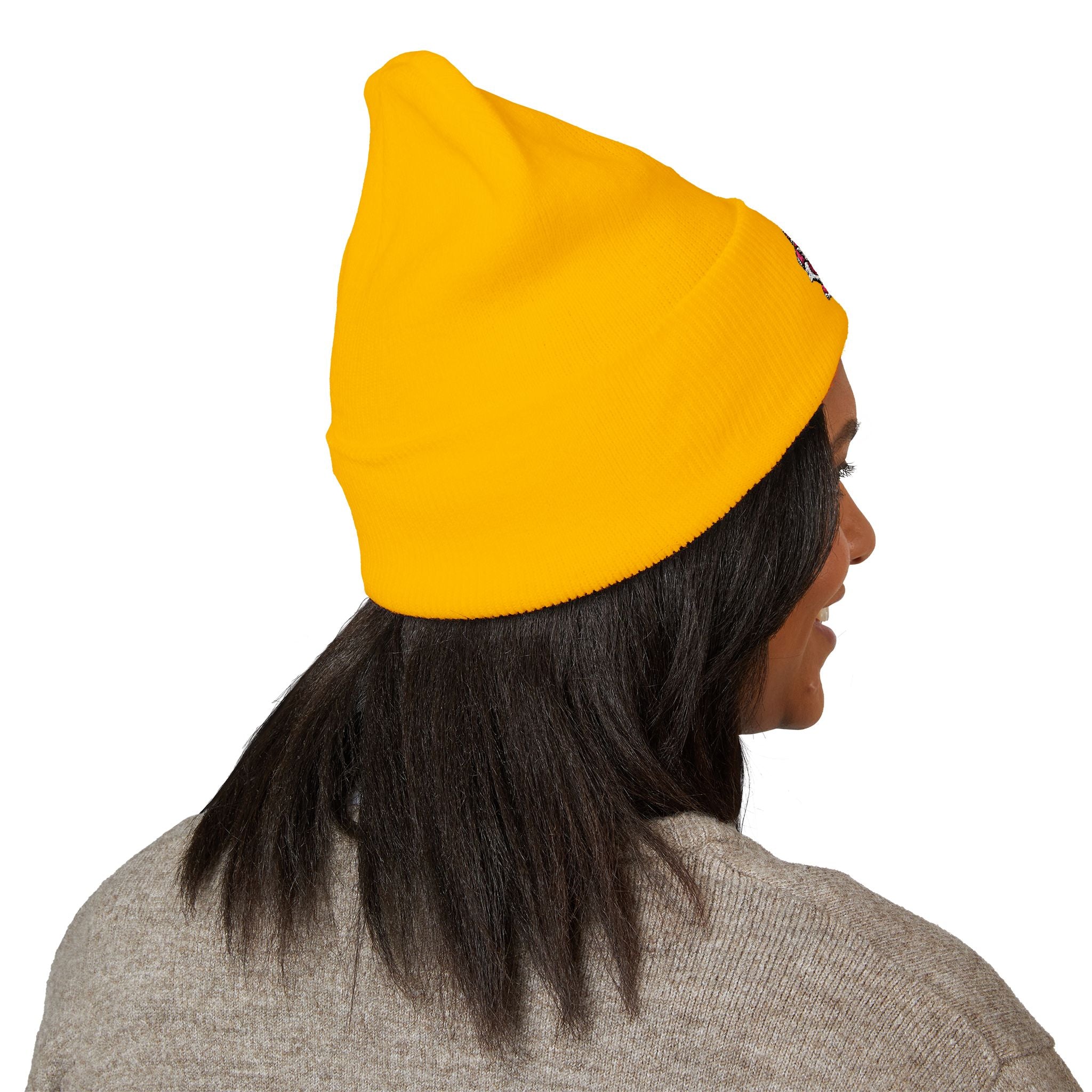 Person wearing a yellow beanie with a logo on a white background